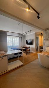 a bedroom with a large bed and a living room at Azurine Pousada in Passo de Torres