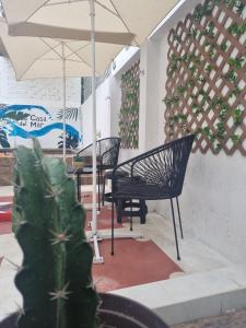 a patio with chairs and a table with an umbrella at La casa del mar in Manzanillo +57 photos