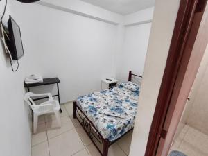 a bedroom with a bed and a table and a chair at Guayacan Hostel in Cali +8 photos