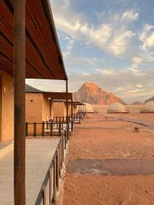 a building in the desert with a mountain in the background at Yara camp in Wadi Rum