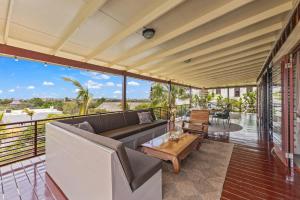a living room with a couch and a table on a balcony at Bali Suites - Penthouse in Willemstad