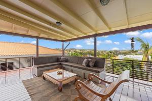 a living room with a couch and a table on a balcony at Bali Suites - Penthouse in Willemstad