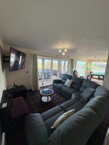 a living room with a couch and a table at Cambrian View in Aberystwyth