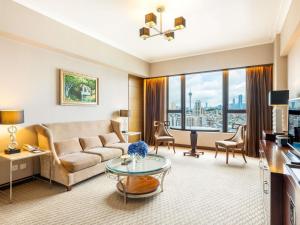 a living room with a couch and a table at Sofitel Macau At Ponte 16 in Macau