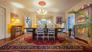 a dining room with a table and chairs at The Farmhouse Manor B&B in St. Catharines