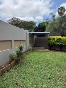 a backyard of a house with a grass yard at Mona Lisa No5 in Polokwane