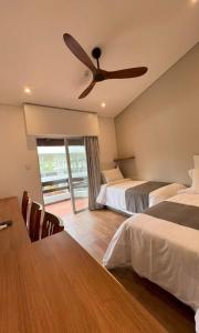 a bedroom with two beds and a ceiling fan at Aguasol Hotel Termal in Termas del Daymán +48 photos