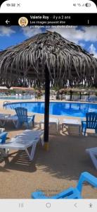 a large umbrella with chairs and a swimming pool at camping siblu le montourey fréjus in Fréjus
