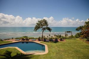 a swimming pool with a view of the ocean at Beijo do Vento Pousada in Arraial d'Ajuda