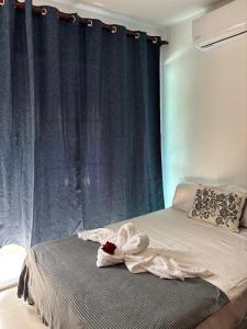 a bedroom with a bed with a blue curtain at Casa Bonita by Mireya in Bayahibe