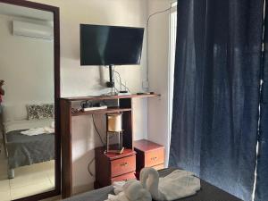 a living room with a television and a mirror at Casa Bonita by Mireya in Bayahibe