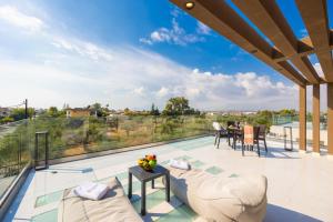 an outdoor patio with a view of a house at Villa Infinity Ena in Kalamaki