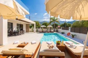 a villa with a swimming pool and a patio at Villa Infinity Ena in Kalamaki