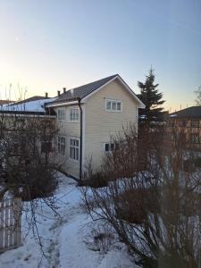 a white house with snow in front of it at Huoneisto Kuusi in Kokkola
