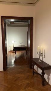 a room with a piano and a table with candles at Studio Balcescu in Sibiu +21 photos