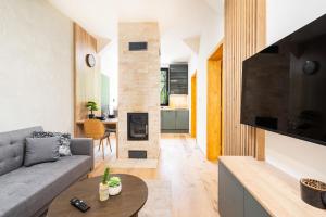 a living room with a couch and a fireplace at Horský apartmán Kuba in Bedřichov