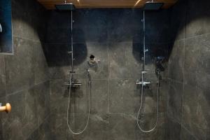 a bathroom with a shower with a glass door at Villa Siltasaari in Sotkamo +34 photos