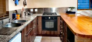 a kitchen with a stove and a sink at Serenity Cottages in Richmond