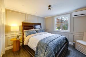 a bedroom with a large bed and a window at Summer Beach Pass: Wooded Martha's Vineyard Escape in Vineyard Haven
