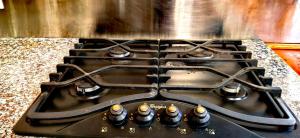 a stove top with a bunch of knobs on it at Serenity Cottages in Richmond