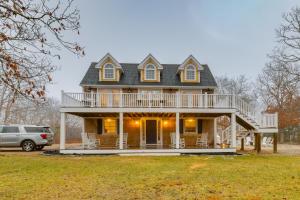 a house with a wrap around porch with a deck at Summer Beach Pass: Wooded Martha's Vineyard Escape in Vineyard Haven