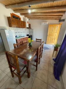 a kitchen with a wooden table with chairs and a refrigerator at Brian Cuello in San Rafael