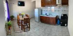 a kitchen with a table and a refrigerator at Brian Cuello in San Rafael +1 photo