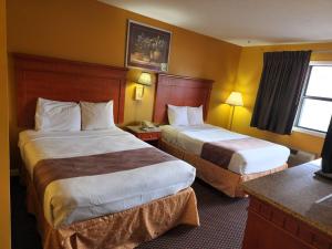 a hotel room with two beds and a window at LACENTER MOTEL in La Center