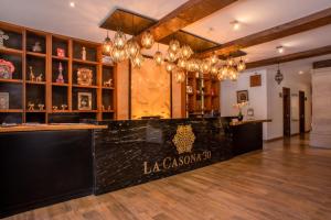 a bar in a room with wooden floors and chandeliers at Hotel La Casona 30 in San Miguel de Allende