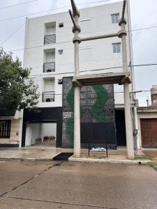 a building with a mural on the side of it at Vicente apart 2 - CON COCHERA in Villa María