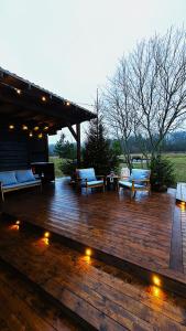a wooden deck with benches and lights on it at Merekalda Glämp in Moldova