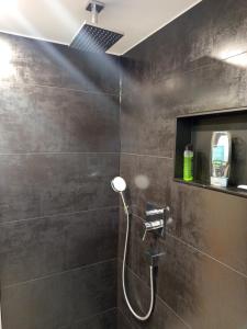 a bathroom with a shower with a shower head at Bebel apartments in Leverkusen