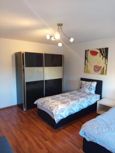 a bedroom with a bed and a painting on the wall at Bebel apartments in Leverkusen