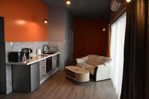 a kitchen with a couch and a table in a room at Vinetas Apartments Nr4 Sunset in Cēsis