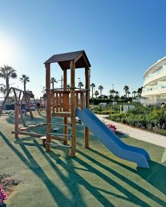a playground with a slide at Penthouse duplex with jacuzzi, 5 min to beach in Chipiona