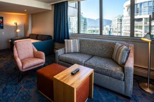 a living room with a couch and a chair at Blue Horizon Hotel in Vancouver