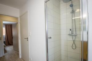 a bathroom with a shower with a glass door at Hesdin Appart Holidays 2 in Hesdin