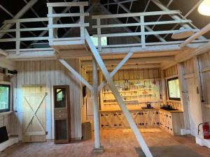 a large kitchen with a ladder in a barn at Wigierska Piertówka 2 in Suwałki +38 photos