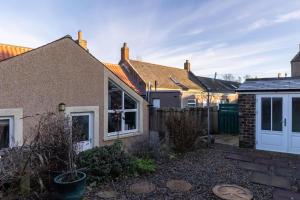 a house with a white door in a yard at 2 Bed in Norham oc-p34181 in Norham