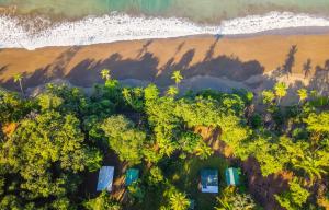 an aerial view of a tropical island with palm trees and the ocean at Playa Ganadito Ecolodge in Drake