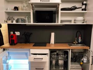 a kitchen with white cabinets and a counter top at Apartment Wohlfühl-Oase mit Pool & Sauna, aktivCard inkl in Sankt Englmar +50 photos