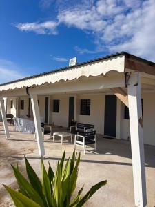 a pavilion with tables and chairs in front of a building at D O M A I N E - D E - L' A N S E - P I S T O L E T - Proche Grande Vigie, Vue Unique in Anse-Bertrand