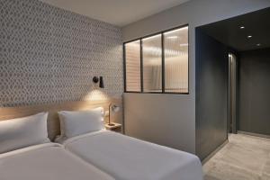 a bedroom with two beds and a window at Elounda Olivia Luxury Villa Spinalonga View in Elounda