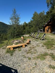 a group of benches sitting on top of a field at Sękata Chata in Szczyrk +10 photos
