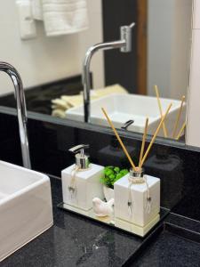 a bathroom counter with a sink and a mirror at Loft Itália in Santa Teresa