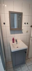 a white bathroom with a sink and a mirror at Liberty Hafen - Arbeiten, Ankommen, Wohlfühlen in Bremerhaven +30 photos