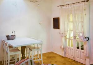 a kitchen with a table and chairs and a window at Can Joseph I Can Toni Platera in Sant Francesc Xavier