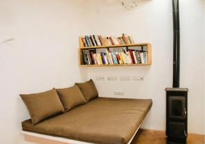 a couch in a room with a book shelf at Can Joseph I Can Toni Platera in Sant Francesc Xavier