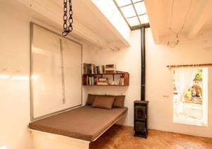 a room with a bed in the corner of a room at Can Joseph I Can Toni Platera in Sant Francesc Xavier +12 photos