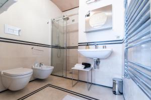 a bathroom with a toilet and a sink and a shower at La suite del convento in Potenza
